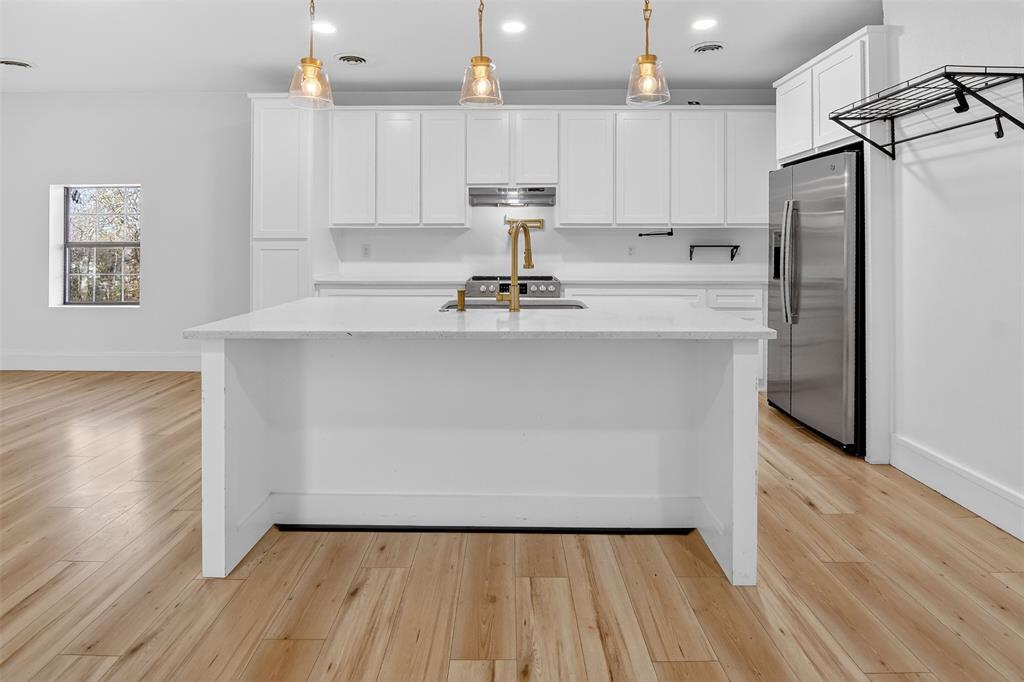 2218 Lynnhaven Road Fort Worth, TX 76103 - Photo 11 of 37 a kitchen with kitchen island a sink appliances and cabinets