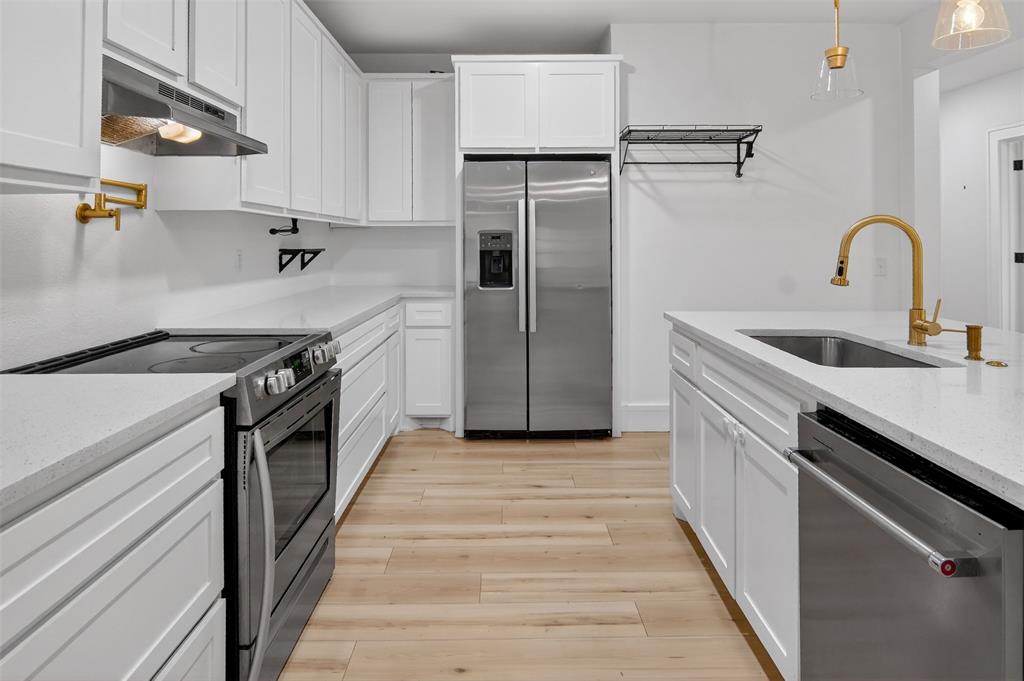 2218 Lynnhaven Road Fort Worth, TX 76103 - Photo 14 of 37 a kitchen with stainless steel appliances granite countertop a sink stove and refrigerator