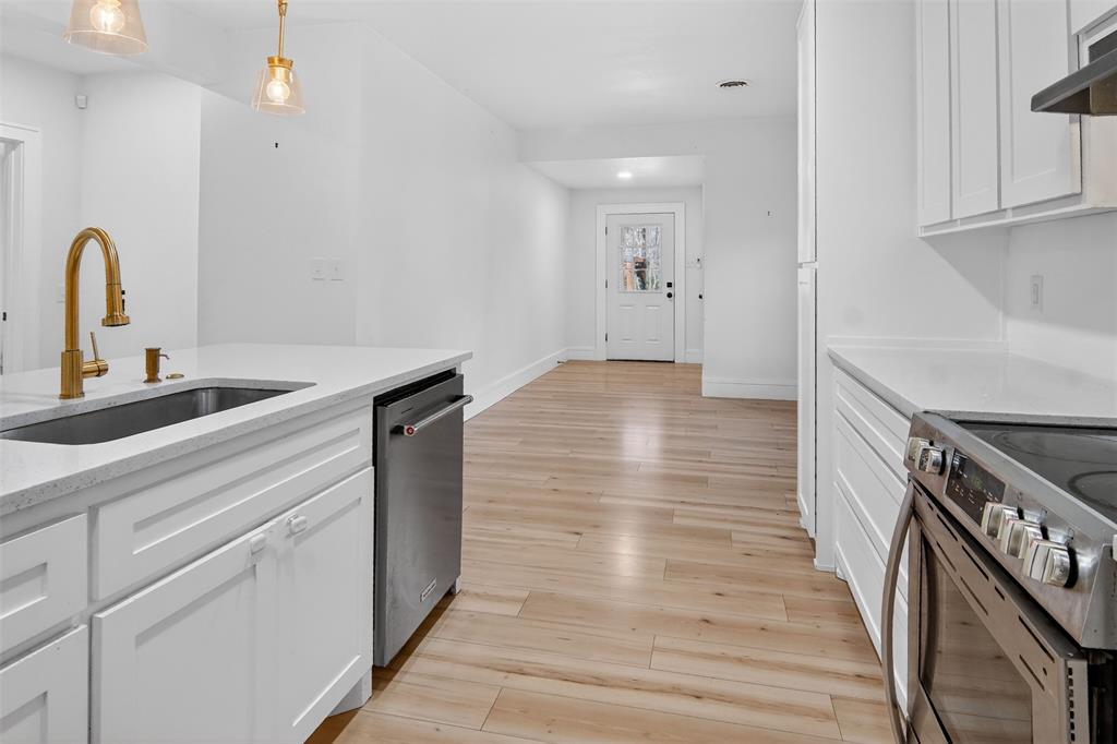 2218 Lynnhaven Road Fort Worth, TX 76103 - Photo 15 of 37 a kitchen with granite countertop a stove and a sink