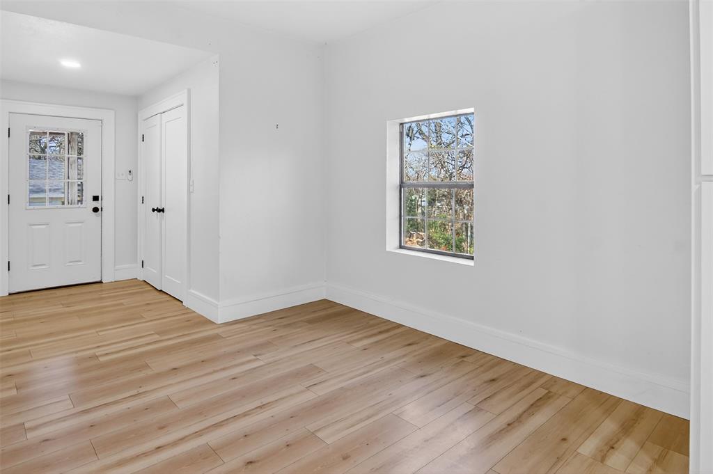 2218 Lynnhaven Road Fort Worth, TX 76103 - Photo 16 of 37 an empty room with wooden floor and windows