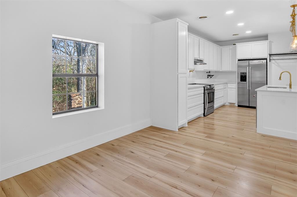 2218 Lynnhaven Road Fort Worth, TX 76103 - Photo 17 of 37 a view of kitchen and wooden floor