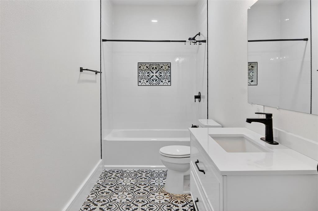 2218 Lynnhaven Road Fort Worth, TX 76103 - Photo 25 of 37 a bathroom with a sink a toilet a vanity and shower