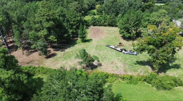 an aerial view of a house with a yard