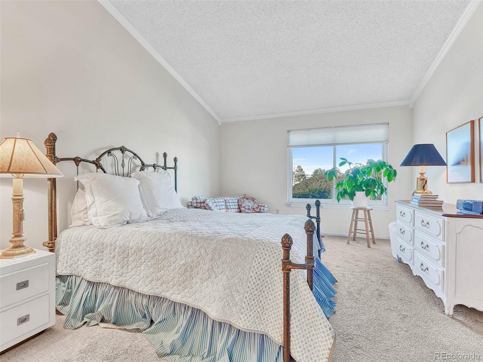9 Stonehaven Court Highlands Ranch, CO 80130 - Photo 16 of 40 a bedroom with a bed and a chandelier