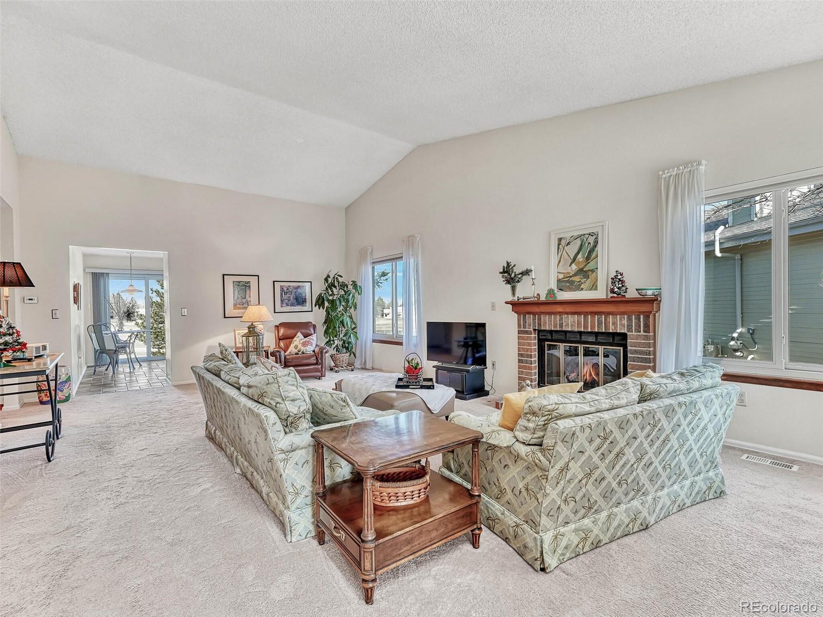 9 Stonehaven Court Highlands Ranch, CO 80130 - Photo 2 of 40 a living room with furniture and a fireplace