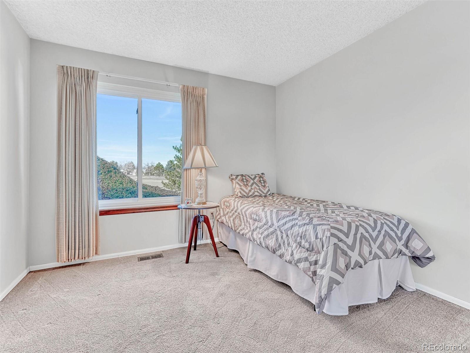 9 Stonehaven Court Highlands Ranch, CO 80130 - Photo 21 of 40 a bed sitting in a room next to a window