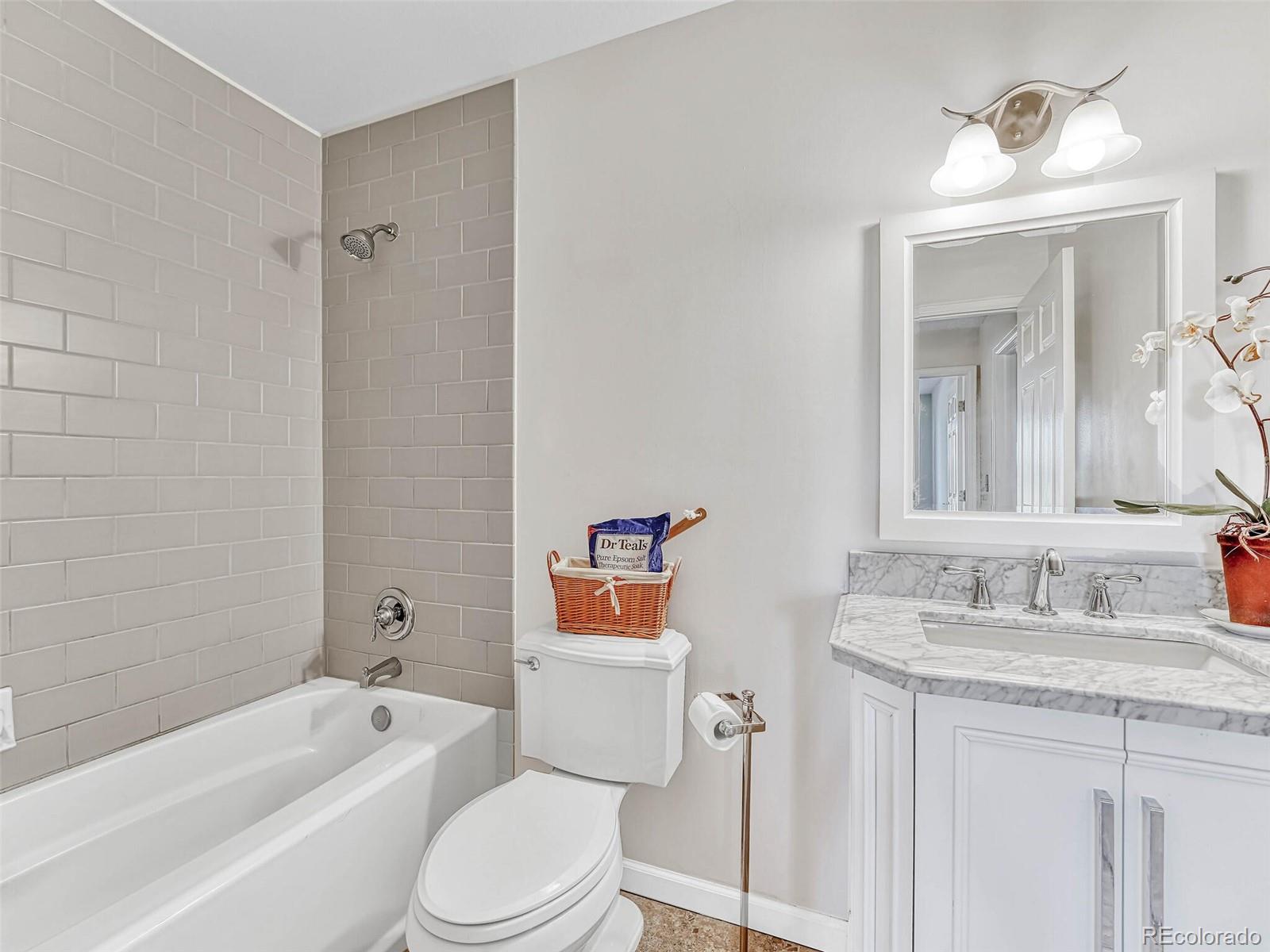9 Stonehaven Court Highlands Ranch, CO 80130 - Photo 23 of 40 a bathroom with a granite countertop sink toilet and shower