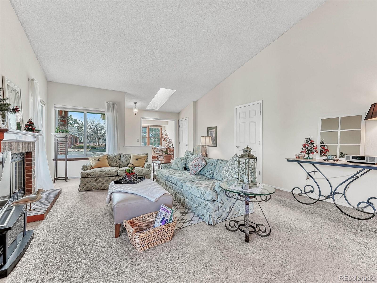 9 Stonehaven Court Highlands Ranch, CO 80130 - Photo 5 of 40 a living room with furniture a window and gym equipment
