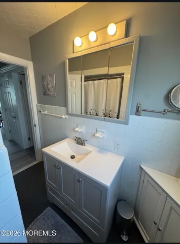 a bathroom with a sink toilet and mirror