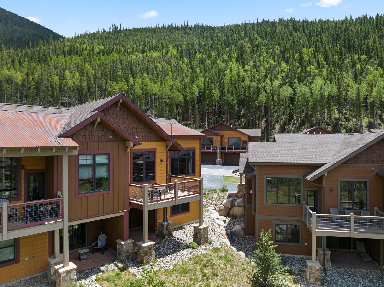 Back of property with a wooded view and a mountain view