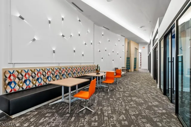 a living room with furniture and a floor to ceiling window