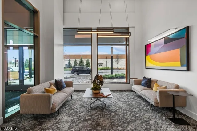 a living room with furniture and a floor to ceiling window