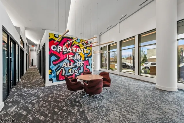 a living room with furniture a fireplace and a chandelier