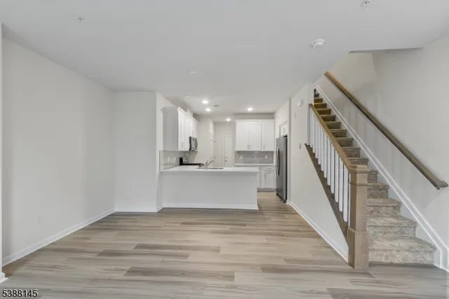 a view of kitchen and hall with wooden floor