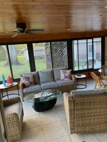 a living room with furniture and a floor to ceiling window
