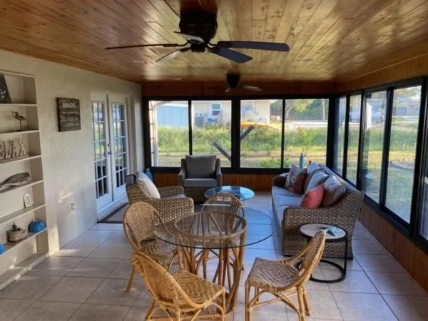 a living room with furniture and a floor to ceiling window