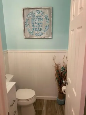 a white toilet sitting next to a shower