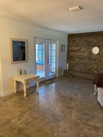 a view of a livingroom with furniture and a flat screen tv