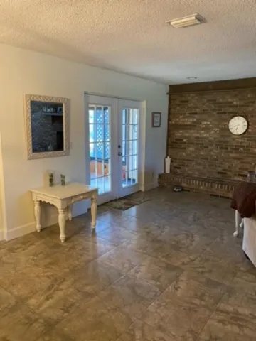 a view of a livingroom with furniture and a flat screen tv