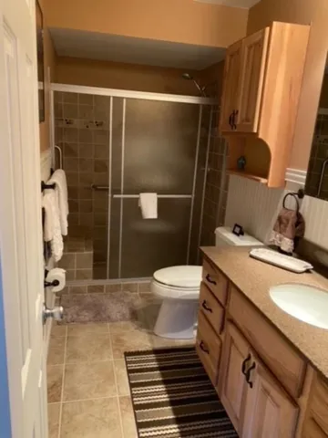a bathroom with a sink toilet and shower