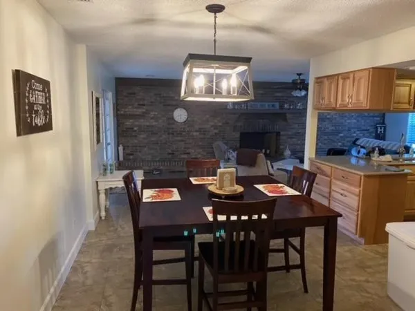 a dining room with a wooden table and chairs