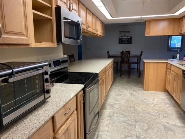 a kitchen with a stove sink and cabinets