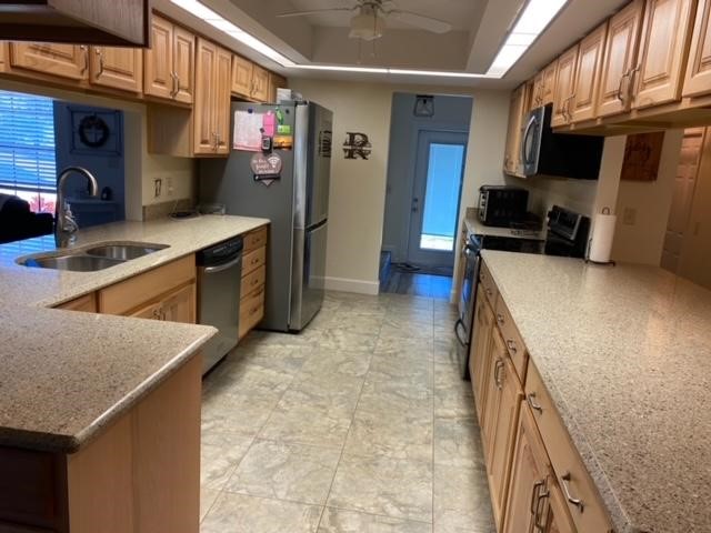 125 Main Street Sebastian, FL 32958 - Photo 9 of 25 a kitchen with stainless steel appliances granite countertop a sink stove and refrigerator