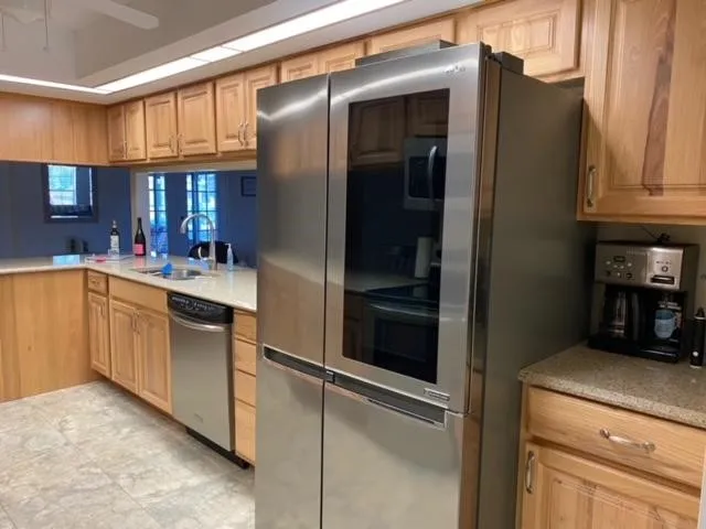a kitchen with a sink and refrigerator