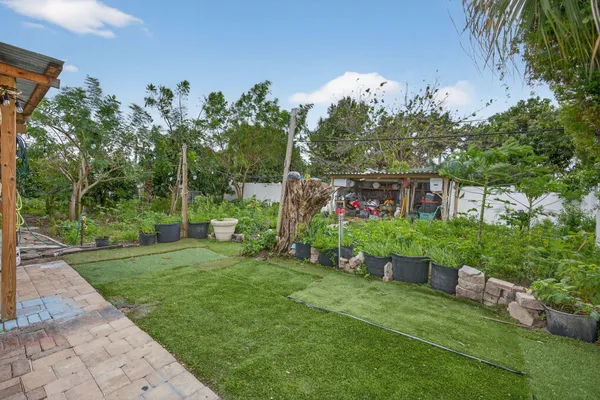 a view of a house with a yard and garden