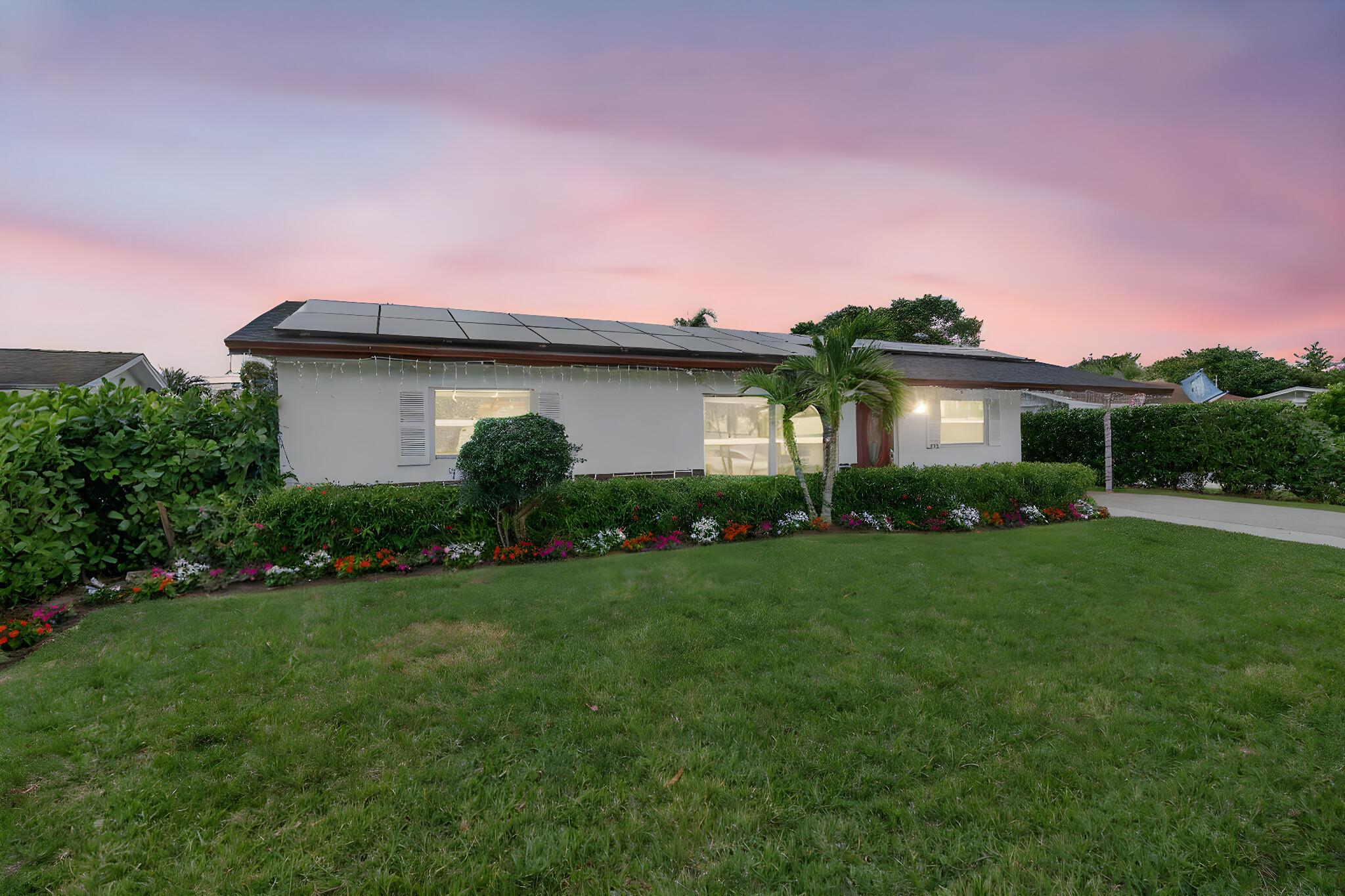 304 Kennedy Street Jupiter, FL 33458 - Photo 3 of 32 a front view of a house with a garden