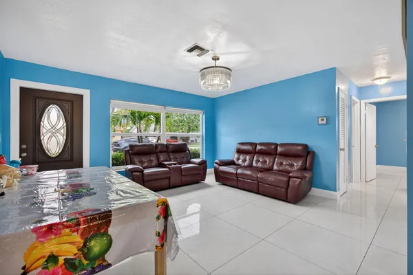a living room with furniture a clock and a window