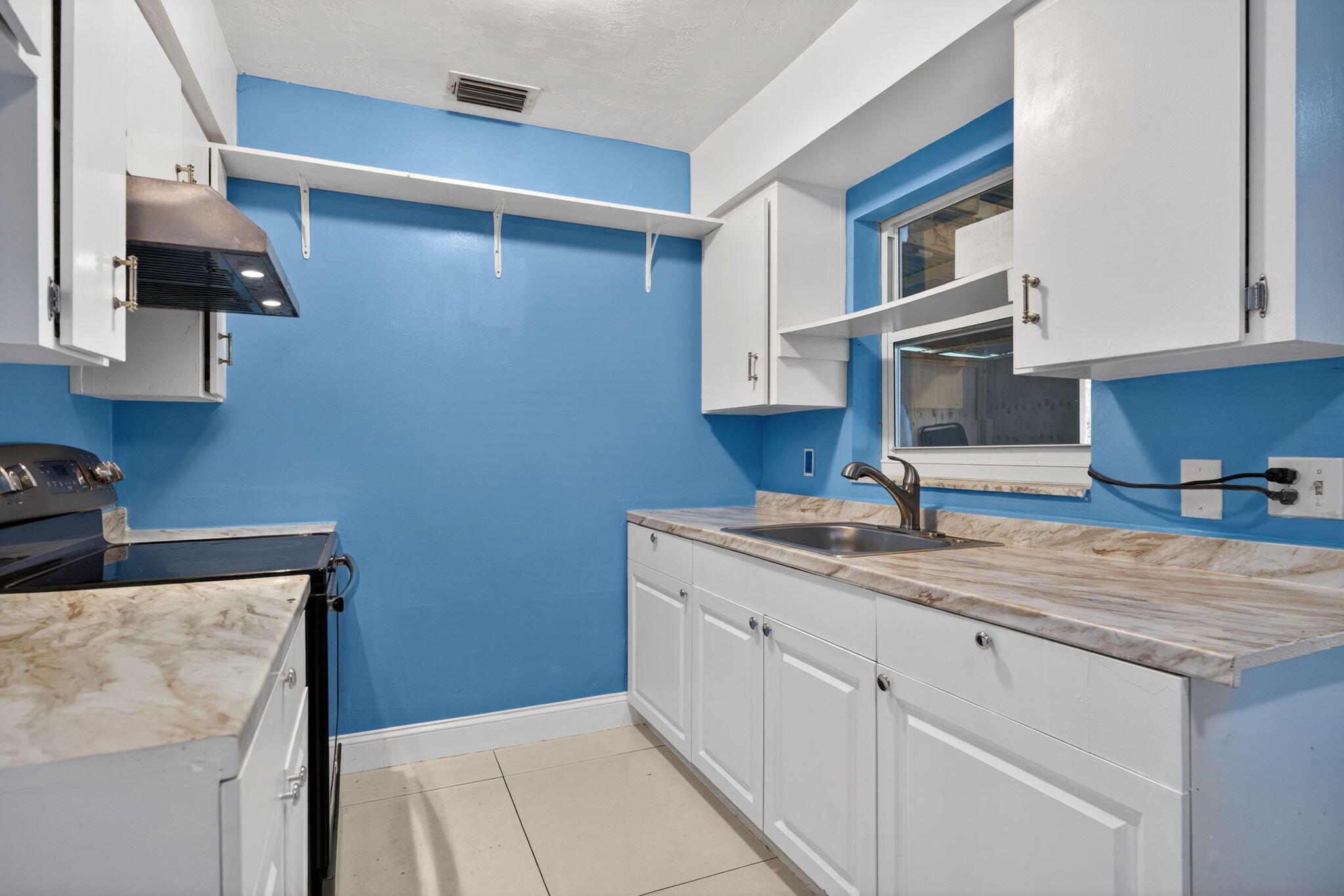 304 Kennedy Street Jupiter, FL 33458 - Photo 9 of 32 a kitchen with a sink dishwasher and cabinets