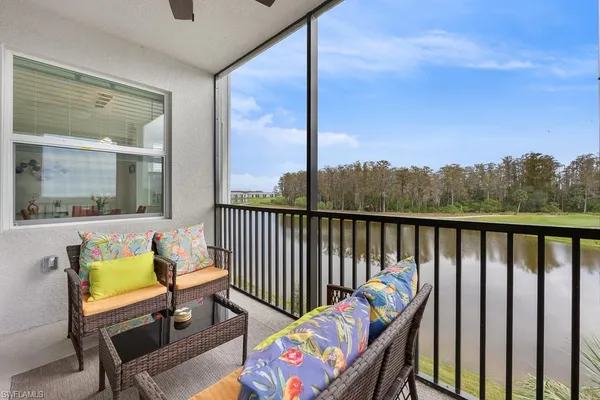 a balcony with table and chairs