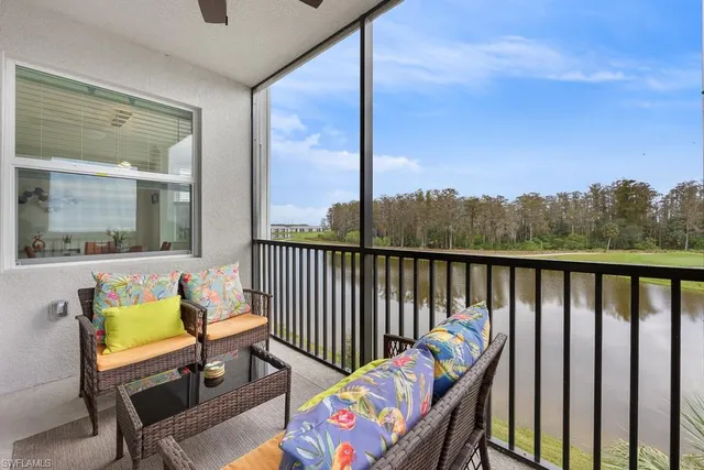 a balcony with table and chairs