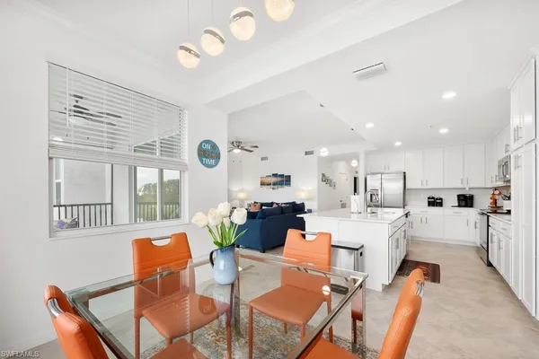 a living room with fireplace furniture and a large window