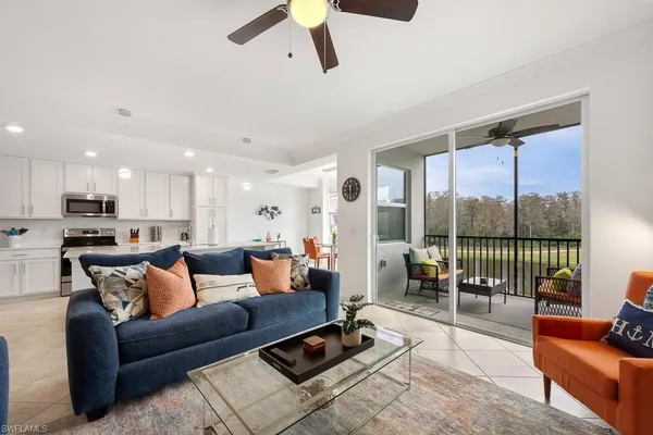 a living room with furniture and a large window