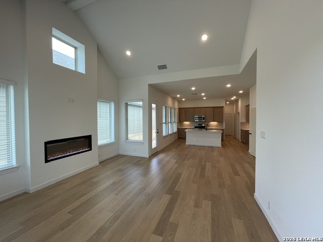 9431 Hidden Stone Schertz, TX 78154 - Photo 5 of 30 a view of a hallway with wooden floor and a fireplace