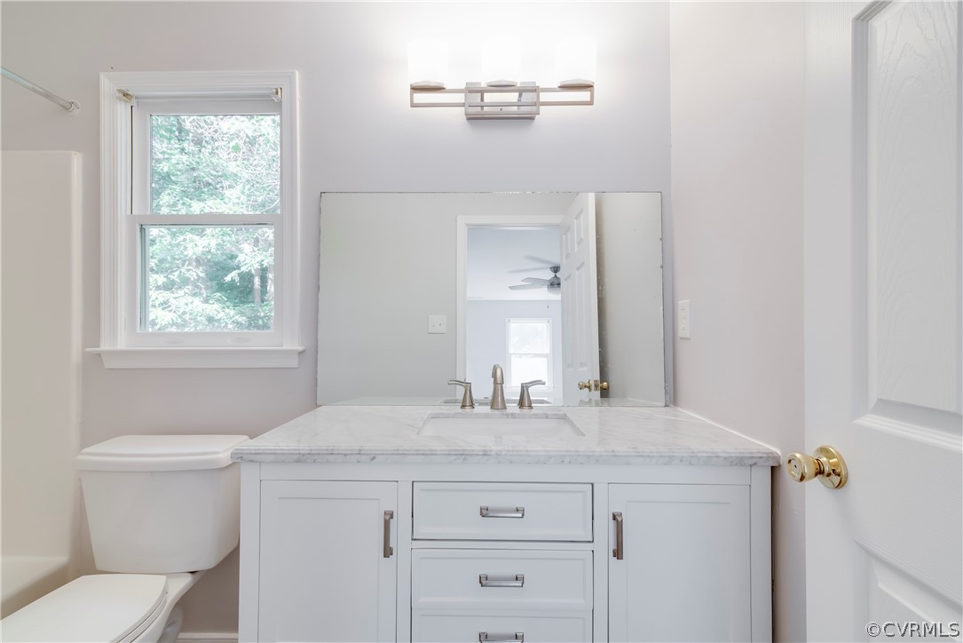 2618 Brookforest Road Midlothian, VA 23112 - Photo 24 of 29 a bathroom with a granite countertop sink a toilet and a mirror