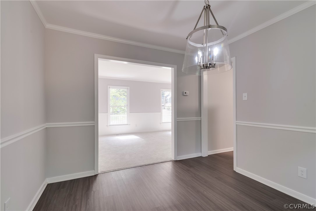 2618 Brookforest Road Midlothian, VA 23112 - Photo 6 of 29 a view of a hallway with wooden floor and a chandelier