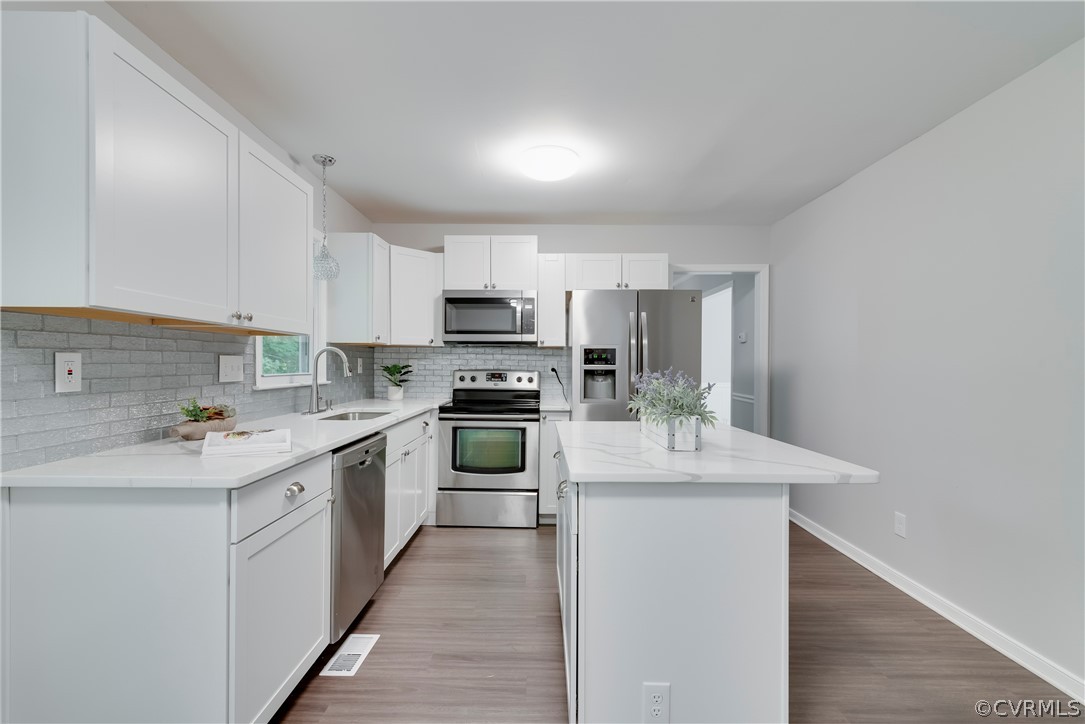 2618 Brookforest Road Midlothian, VA 23112 - Photo 7 of 29 a kitchen with a sink a stove top oven and white kitchen