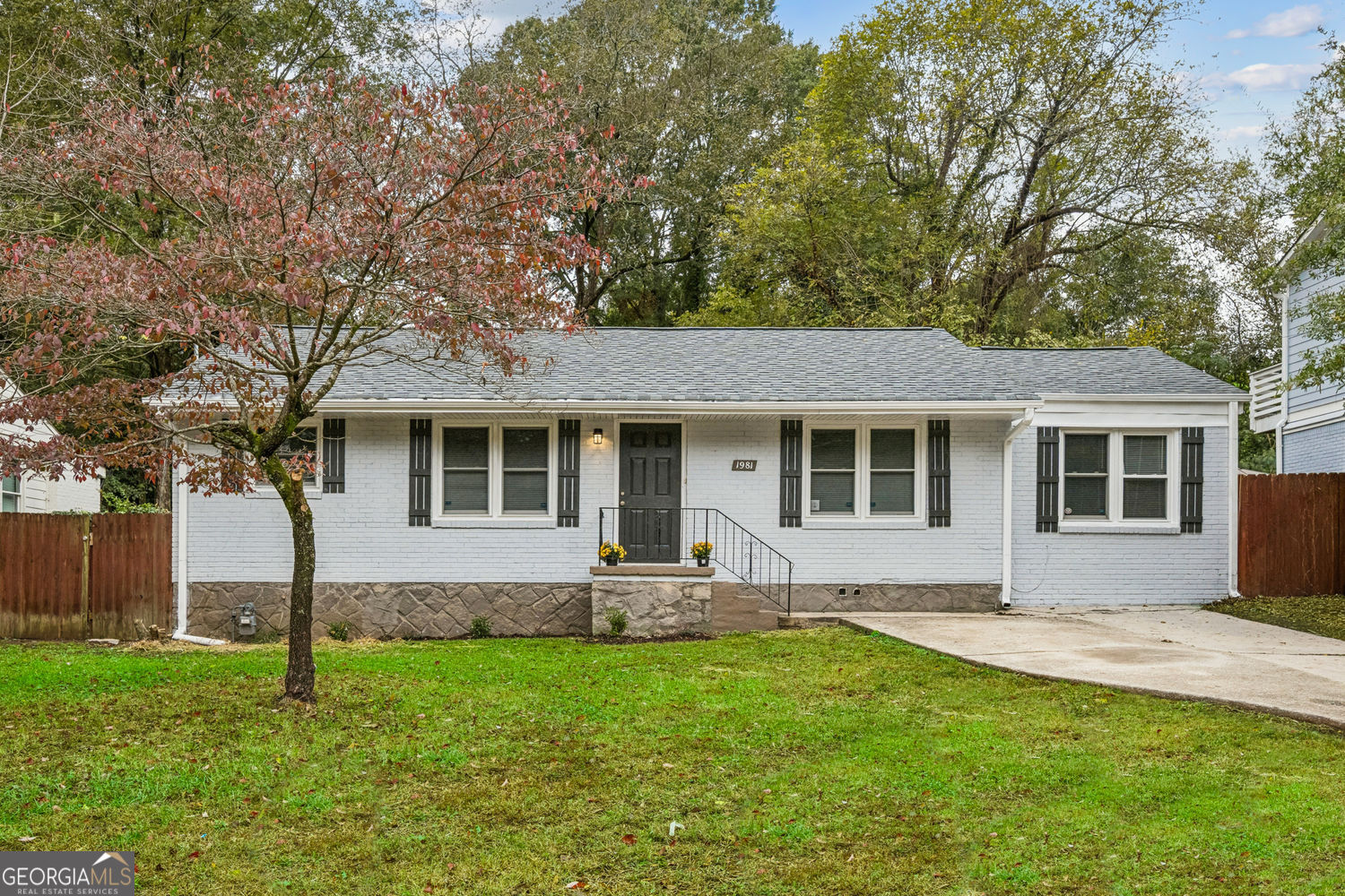 a front view of house with yard and green space