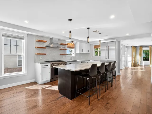 a kitchen with a sink cabinets and wooden floor