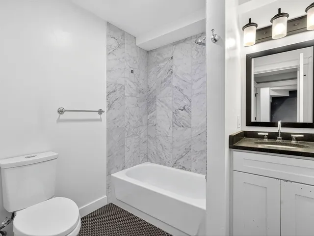 a view of a big room with wooden floor and windows