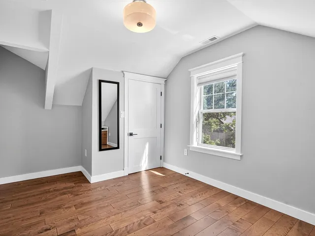 a view of a patio with table and chairs with wooden floor and fence