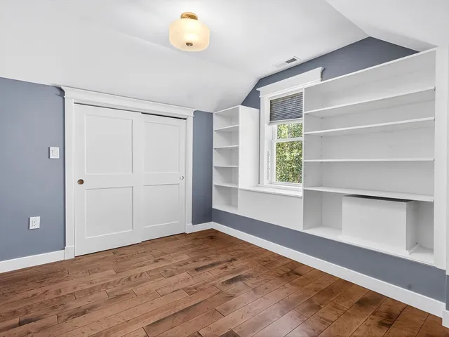 a view of a chair and table in backyard of the house