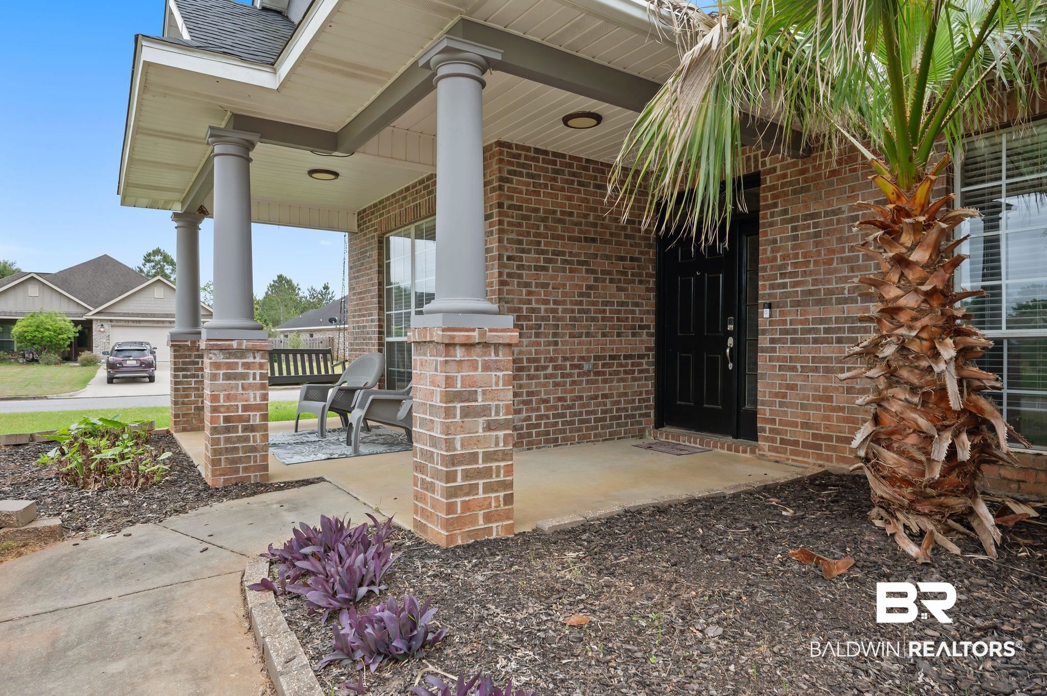 1287 Pembroke Way Foley, AL 36535 - Photo 4 of 39 Property entrance featuring covered porch, brick siding, and roof with shingles