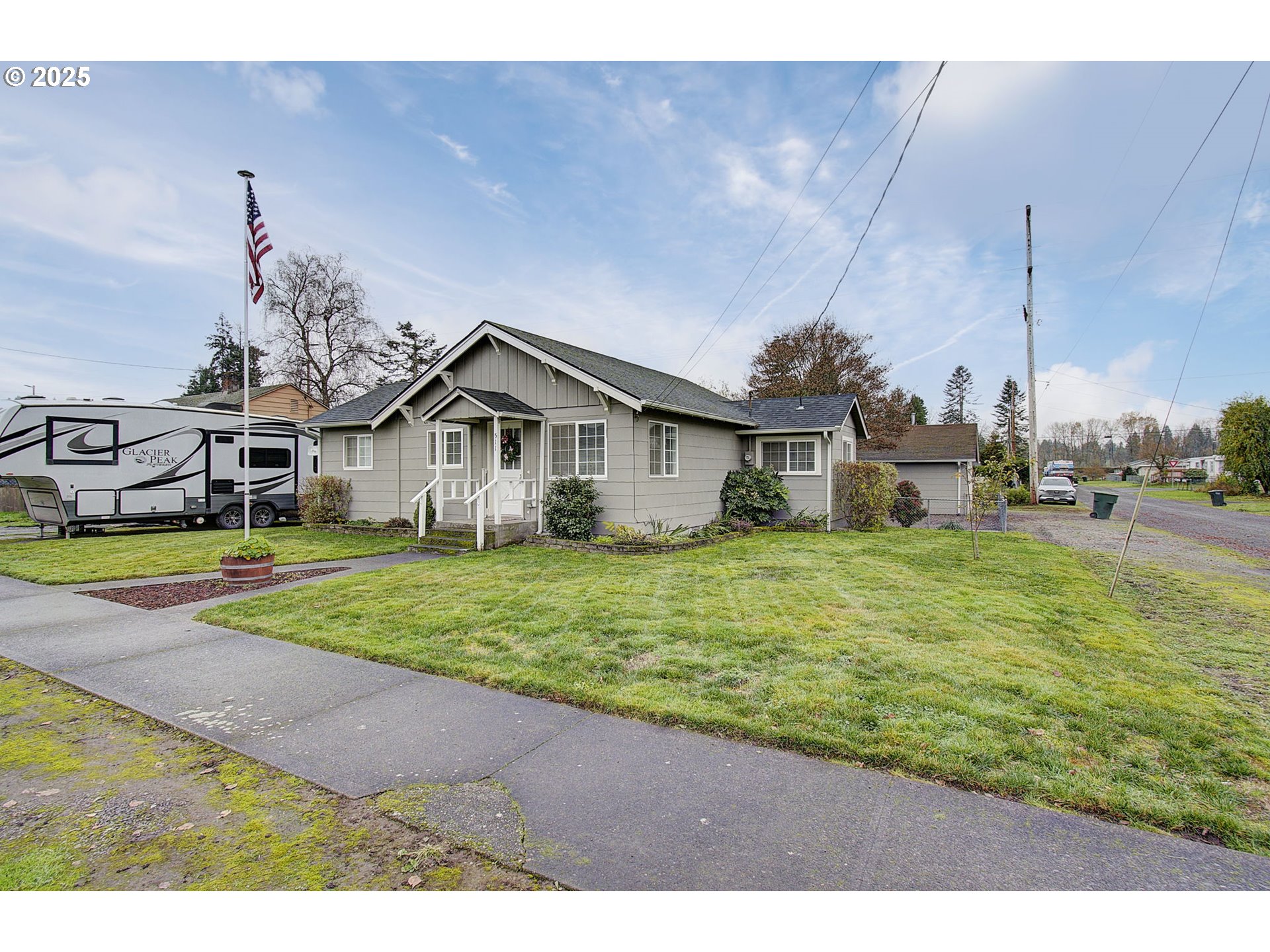 511 4th Avenue Southwest Castle Rock, WA 98611 - Photo 2 of 37 a view of a house next to a big yard with big trees