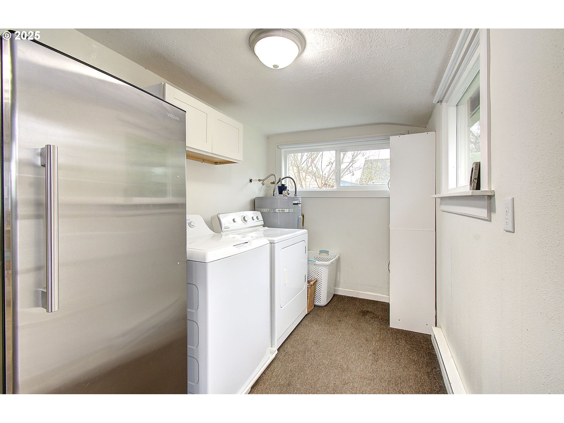 511 4th Avenue Southwest Castle Rock, WA 98611 - Photo 23 of 37 a utility room with cabinets washer and dryer