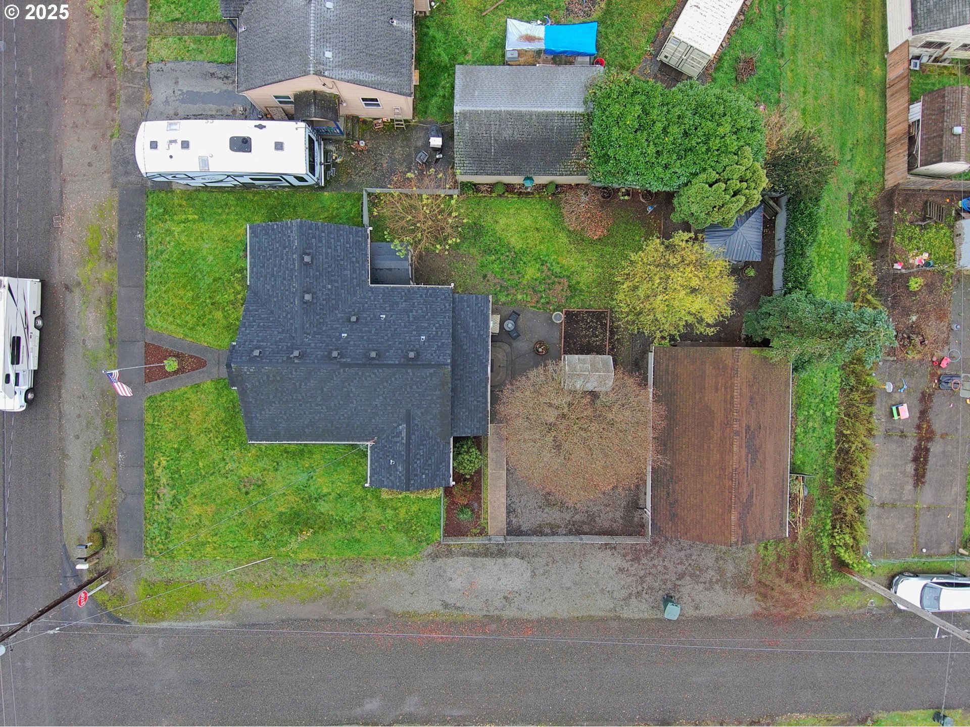 511 4th Avenue Southwest Castle Rock, WA 98611 - Photo 36 of 37 an aerial view of a house with a yard and a car parked