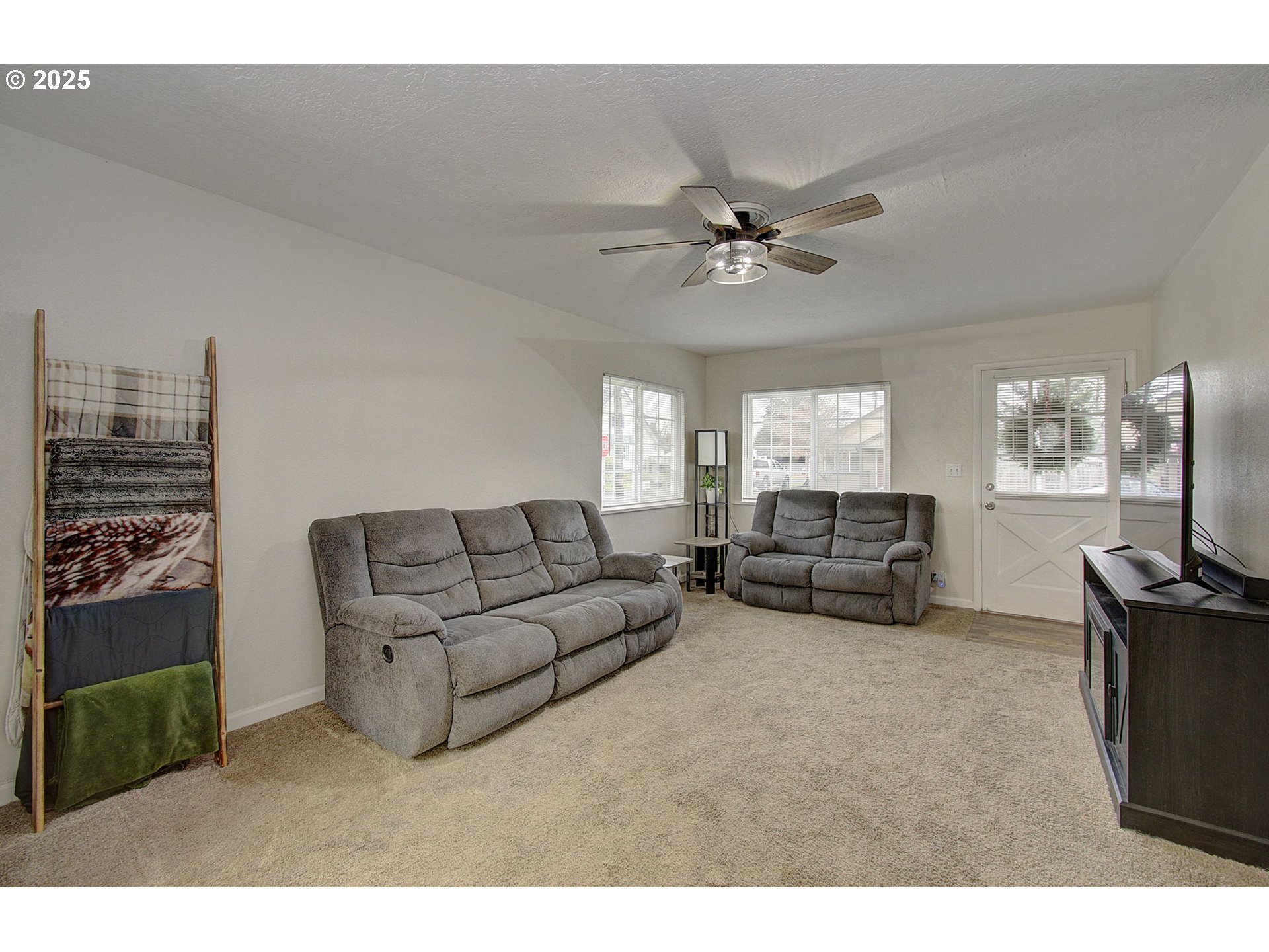 511 4th Avenue Southwest Castle Rock, WA 98611 - Photo 6 of 37 a living room with furniture a flat screen tv and a fireplace